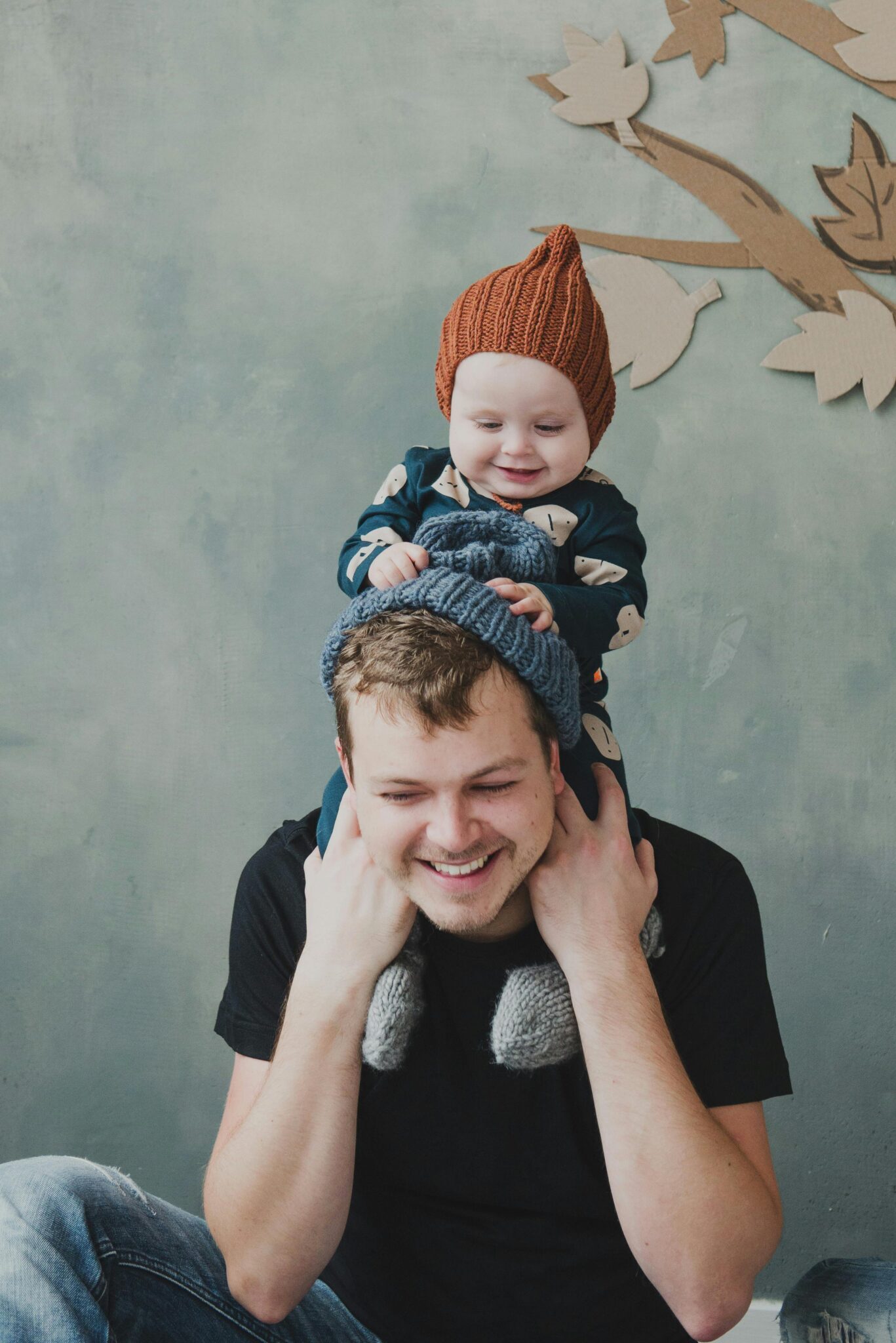 Heartwarming portrait of a father and son indoors, sharing a playful moment together.